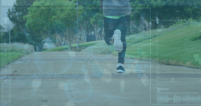 Running male wearing leggings and sneakers on concrete park path with grass banks and HUD data