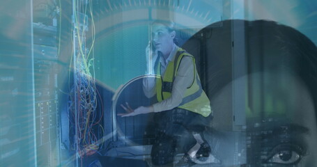 Kneeling IT tech holding smartphone, explaining server rack cables in data center, with HUD overlay