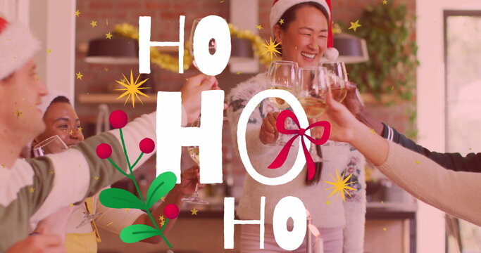 Naklejki Raising wine glasses group wearing Santa hats and sweaters toasting at kitchen counter, copy space
