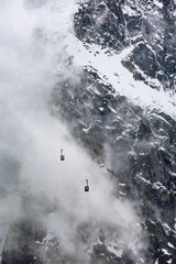 Cable car of Aiguille du Midi against the stormy clouds, Chamonix, Mont Blanc, France, Europe