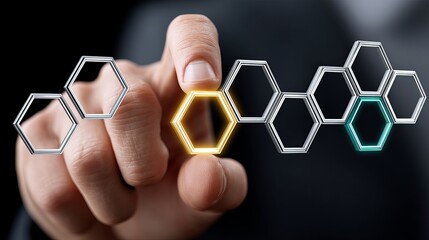 A close-up of a male hand interacting with hexagonal digital shapes, symbolizing innovation.