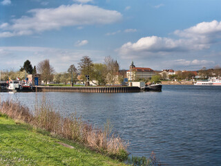 Fototapeta premium Beautiful view of the River Weser in Germany with the city of Hameln visible under a cloudy sky