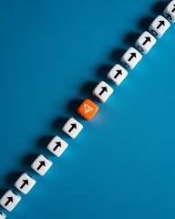 A diagonal line of white dice with upward arrows and one orange dice on a blue colored background