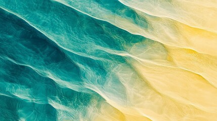 Aerial view of turquoise water meeting a sandy beach creating abstract patterns.