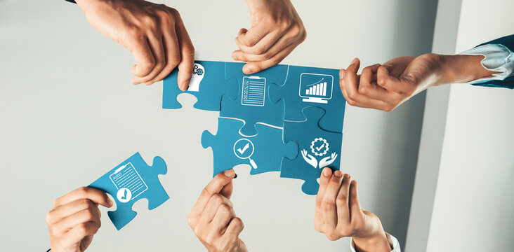 A dynamic scene of diverse hands working together to assemble blue puzzle pieces, symbolizing collaboration, growth, and successful teamwork in a modern office environment. Amity
