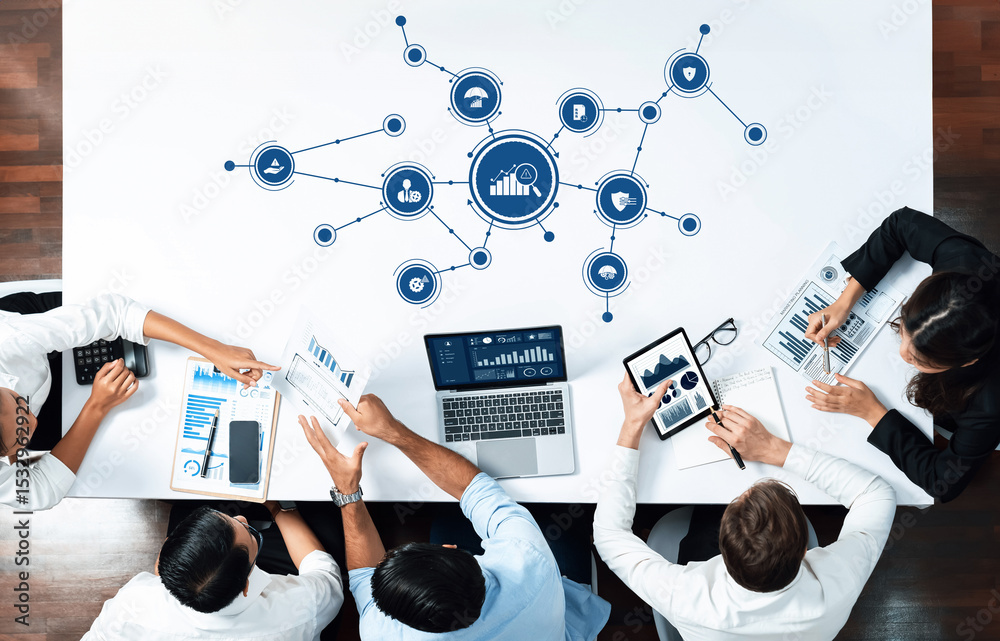 Aufkleber A diverse team engages in a collaborative meeting, utilizing digital tools and charts to discuss business management strategies and data insights in a modern workspace. Amity