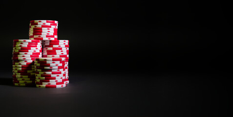Pile of red and white poker chips isolated on a black background
