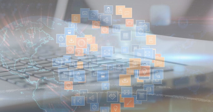 Floating digital icons forming circular cluster at desk, with laptop keyboard and wireframe globe