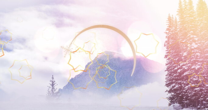 Fototapeta Displaying snowy pines, mountain peak rising in winter valley fog with golden stars, pastel flares