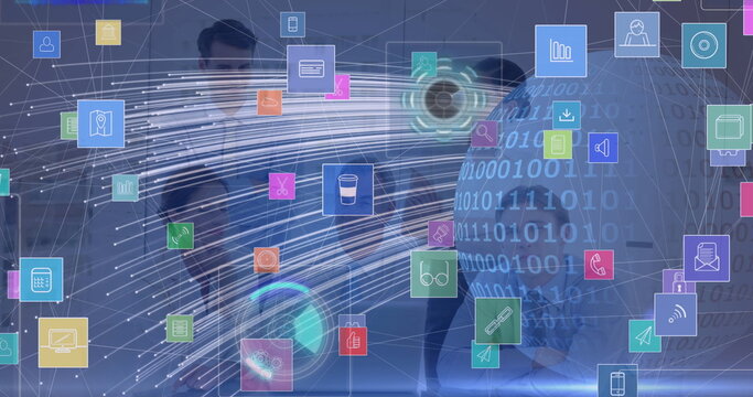 Collaborating team presenting holographic data in office with floating icons, globe and tablet