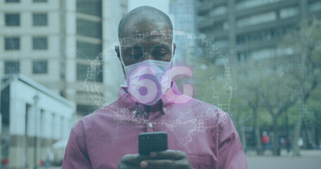 Man wearing pink shirt and mask using smartphone to view 6G holographic map in urban plaza