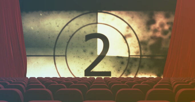 Fototapeta Showing large projection screen counting down number two in cinema auditorium, red velvet seats