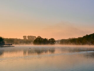 Closeup shot of a landscape with lake and reflection of trees during sunset