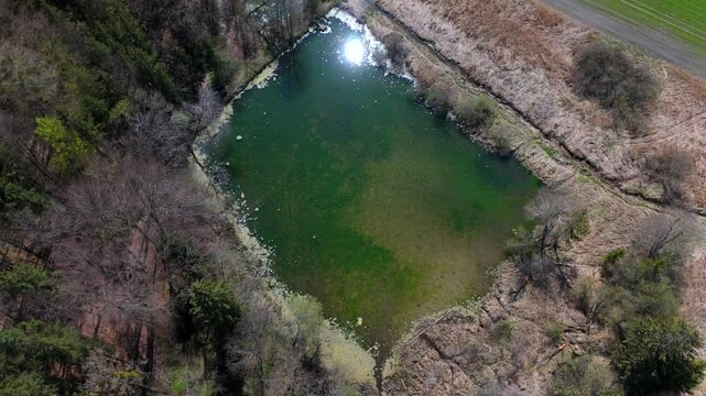 Luftaufnahme Spiegelweiher and surrounding ponds in Bavaria, Germany, Grafing bei Munchen. Scenic spring landscape with shimmering lakes, tranquil paths and flourishing nature in southern Deutschland