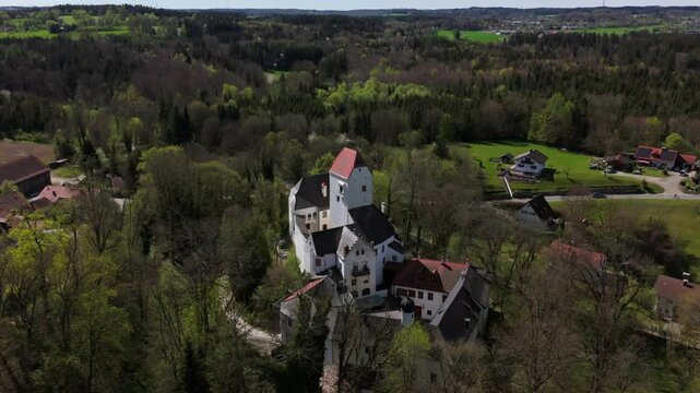 Aerial view of Schloss Elkofen, historic Bavarian castle nestled in green meadows near Grafing, Upper Bavaria. Scenic medieval landmark, blending nature, heritage, timeless architecture. Burg Elkofen