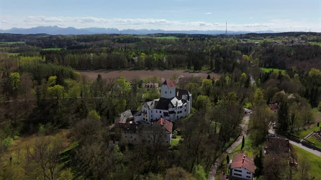 Aerial view of Schloss Elkofen, historic Bavarian castle nestled in green meadows near Grafing, Upper Bavaria. Scenic medieval landmark, blending nature, heritage, timeless architecture. Burg Elkofen