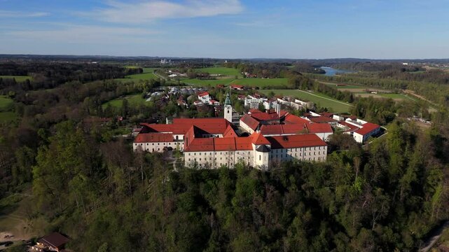 Aerial view Luftaufnahme of Attel Monastery and St. Michael Church on Attel Hill by Inn River, near Wasserburg am Inn, Bavaria. Historic Benedictine site, scenic spring landscape, rural Germany charm