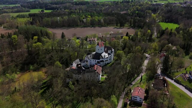Aerial view of Schloss Elkofen, also known as Burg Elkofen, Schloss Elkhofen, near Grafing bei Muenchen, Germany. A medieval fortress surrounded by green fields in the Bavarian countryside. 