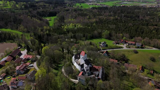 Aerial view of Schloss Elkofen, historic Bavarian castle nestled in green meadows near Grafing, Upper Bavaria. Scenic medieval landmark, blending nature, heritage, timeless architecture. Burg Elkofen