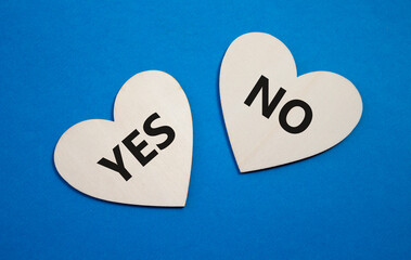 Yes or No symbol. Concept word Yes or No on wooden hearts. Beautiful blue background. Business and...
