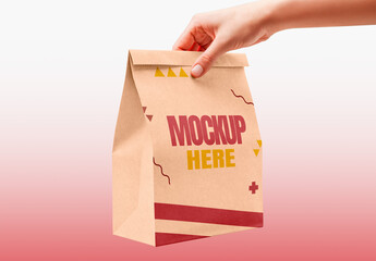 Hand Holding a Paper Kraf Bag Mockup