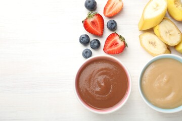 Baby food. Tasty puree in bowls and different ingredients on white wooden table, flat lay