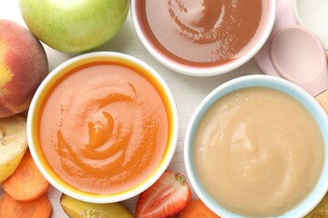 Baby food. Tasty puree in bowls and different ingredients on table, flat lay