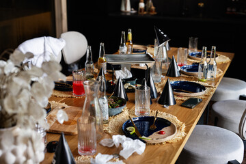Casual party table with drinks and decorations after a lively gathering