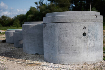 Close-up view of concrete structures arranged outdoors on a gravel area