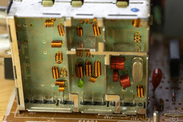 An old circuit board with various electronic components. It features resistors, capacitors, and a...