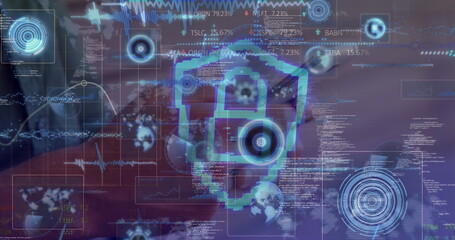 Floating pixelated digital shield icon above laptop on desk, with holographic code overlays