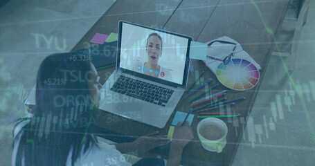 Woman wearing white blouse taking notes in online meeting at desk, with color wheel, copy space