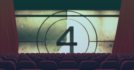Displaying vintage countdown number 4 on projection screen in theater, with red curtains and seats