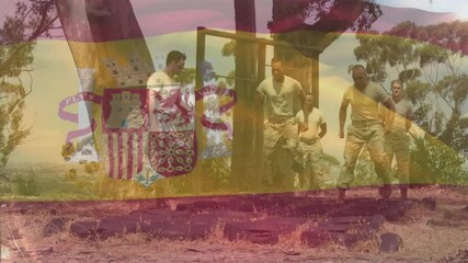 First soldier stepping forward and leading team through tire training drill with faint Spanish flag - Powered by Adobe