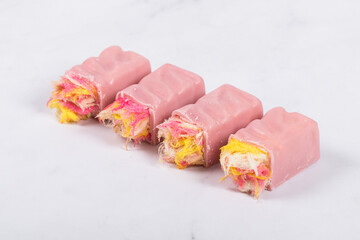 Angel Hair. Raspberry white chocolate candy bar. With colored cotton candy. White background. Close-up.