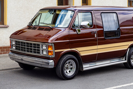 Classic brown and beige vintage van parked on street