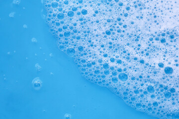 Blue water with white foam bubbles