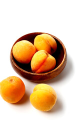 Fresh ripe apricots on a white background.