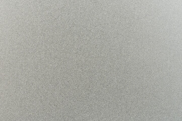 Textured gray surface with subtle variations reflects light in soft, muted manner