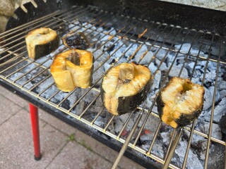 Grilled fish steaks on charcoal barbecue for summer cooking experience. Grilled sturgeon steaks