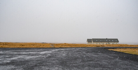 Holiday hotel in the countryside of iceland under falling snow near road. Snaefellsnes peninsula...