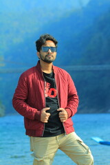 A man was standing near a Lake