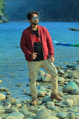 A man was standing near a Lake