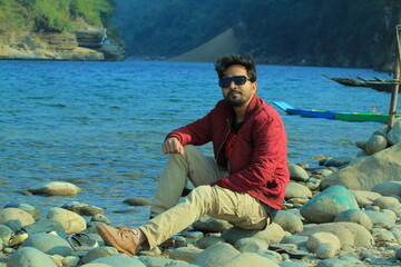 A man was standing near a Lake