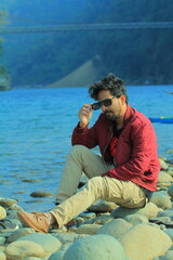 A man was standing near a Lake