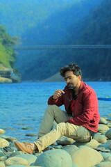 A man was standing near a Lake