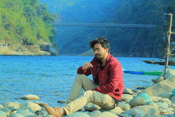 A man was standing near a Lake