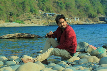 A man was standing near a Lake