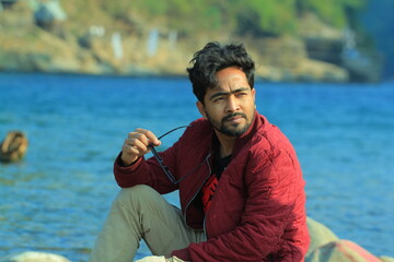 A man was standing near a Lake