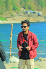 A man was standing near a Lake